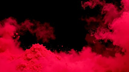 Vibrant crimson powder explodes against a stark black background creating a dramatic and textured artistic effect perfect for design projects.