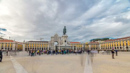 Fototapeta premium Triumphal arch at Rua Augusta and bronze statue of King Jose I at Commerce square timelapse hyperlapse in Lisbon, Portugal.