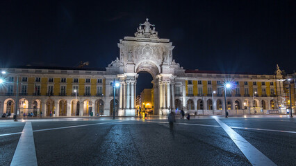 Fototapeta premium Triumphal arch at Rua Augusta at Commerce square night timelapse hyperlapse in Lisbon, Portugal.