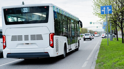 City bus navigates through urban streets on route 33 in a busy neighborhood during the afternoon hours