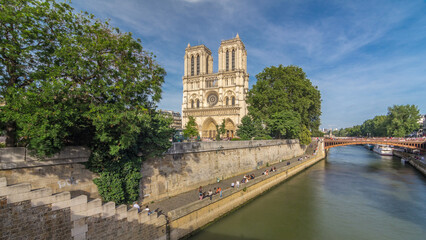 Front facade of cathedral of Notre Dame de Paris, with square full of people in front timelapse hyperlapse