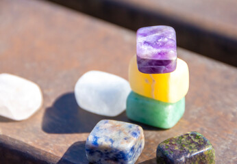 Natural mineral amethyst among other natural minerals. Semi-precious multi-colored stones, minerals close-up. mineralogy. Collection of minerals.