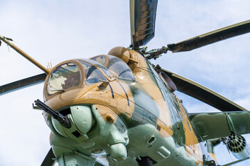 Camouflaged Soviet Mi-24 military attack helicopter in low flight