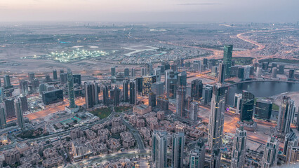 Fototapeta premium Downtown of Dubai night to day timelapse before sunrise. Aerial view with towers and skyscrapers