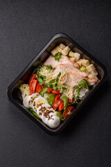 Bowl with caesar salad with chicken, parmesan cheese, tomatoes, croutons, lettuce leaves