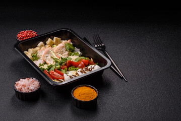Bowl with caesar salad with chicken, parmesan cheese, tomatoes, croutons, lettuce leaves