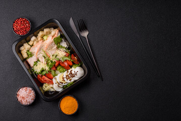 Bowl with caesar salad with chicken, parmesan cheese, tomatoes, croutons, lettuce leaves