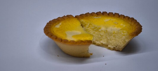 Egg tarts that are crispy on the outside and soft on the inside. Egg tarts that have a rich and creamy egg aroma. Egg tarts on white background.