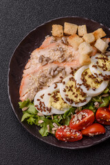 Bowl with caesar salad with chicken, parmesan cheese, tomatoes, croutons, lettuce leaves