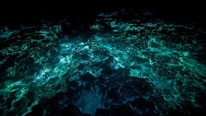 Fototapeta premium Bioluminescent waves glow over volcanic rock; dark ocean depths reveal silent anglerfish silhouettes.