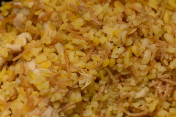 Authentic Cypriot meal of bulgur wheat mixed with small pasta and tender chicken pieces. Homemade comfort food rich in flavor and tradition.