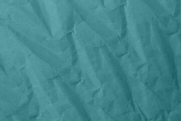 Abstract wrinkled teal blue crumpled paper texture background