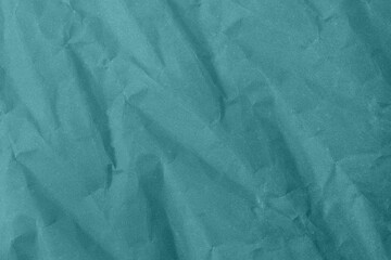 Abstract wrinkled teal blue crumpled paper texture background