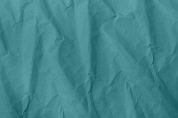 Abstract wrinkled teal blue crumpled paper texture background