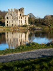 Obraz premium Stunning remains of Menlo castle with reflection in river Corrib. Popular landmark in Galway city, Ireland. Nobody. Travel and tourism. Rich people mansion ruin. Irish history.