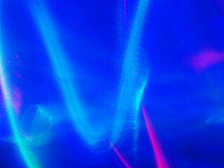 A blue and purple swirl of light and color. The blue is very bright and the purple is very dark. Abstract background for design. Light glow.