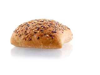 One small premium roll with seeds and grain on white background with reflection. Fine bakery product made from high quality premium ingredients, Small taste crusty bread.