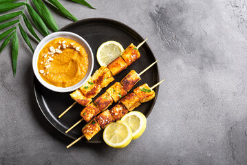 Grilled tofu satay skewers and peanut spicy sauce