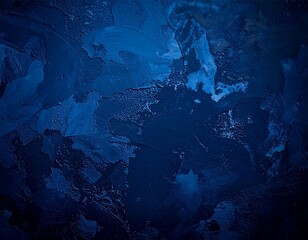 A textured blue wall with various paint splatters, set against a contrasting dark background, showcasing artistic expression