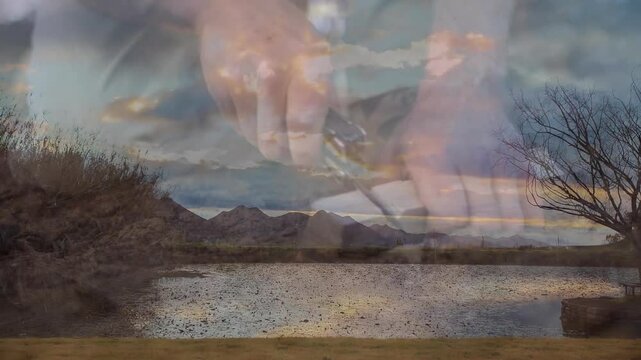 man's hands unfolding multitool knife over desert pond, displaying gear marketing concept