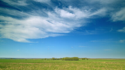 The Beautiful and Serene Countryside Featuring a Bright Blue Sky with Fluffy White Clouds