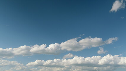 A Serene and Cloudy Sky Painting with a Bright Blue Background and Fluffy White Clouds