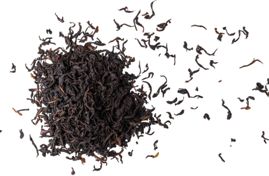 A close-up view of loose black tea leaves scattered on a white background. showcasing their texture and color. ideal for culinary or beverage-related content