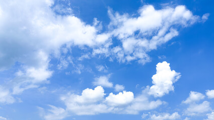 Clear blue sky background with fluffy white clouds on a sunny day. Blue sky with cloud. Soft white clouds floated in the blue sky that looked like soft cotton floating in the air. Beautiful blue sky