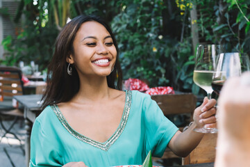 Cheerful women drinking wine in cafe