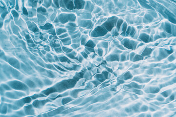 Blue water background with waves and glare