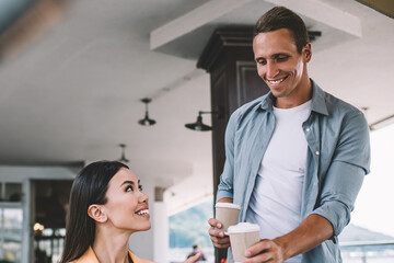 Ethnic female freelancer having coffee break with male companion