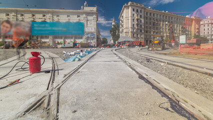 Tram rails at the stage of their installation and integration into concrete plates on the road...