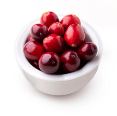 Large cranberry isolated. Heap of fresh cranberries in white bowl on white background.