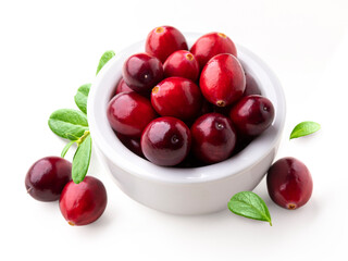 Large cranberry isolated. Heap of fresh cranberries in white bowl with some crushed cranberries and leaves on white background.