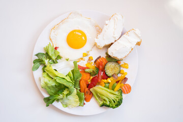 Tasty and healthy breakfast, scrambled eggs with vegetables, salad and cream cheese toasts, healthy...