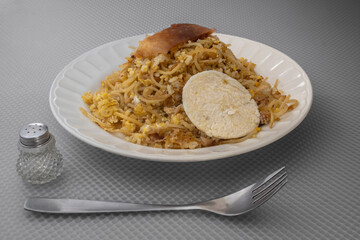 Fried rice with meat, arepa, noodles.
