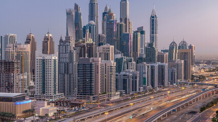 Dubai Marina skyscrapers aerial top view before sunrise from JLT in Dubai night to day timelapse, UAE.