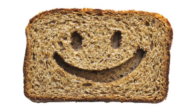 A slice of bread with a smiley face drawn on it