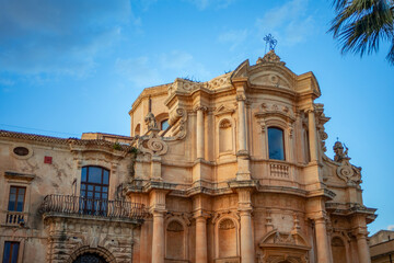 Fototapeta premium Facade of the Church of Saint Dominic of Noto, Sicily, Italy, a UNESCO World Heritage Site, in the golden light of sunset