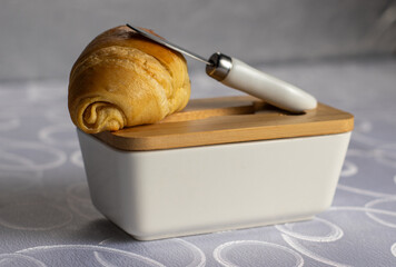 Fresh Bread with Butter Knife and Wooden Lid Dish