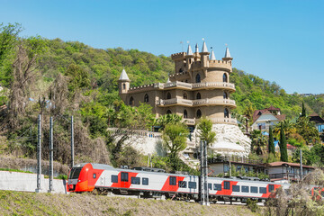 Passenger train moves along the mountain.