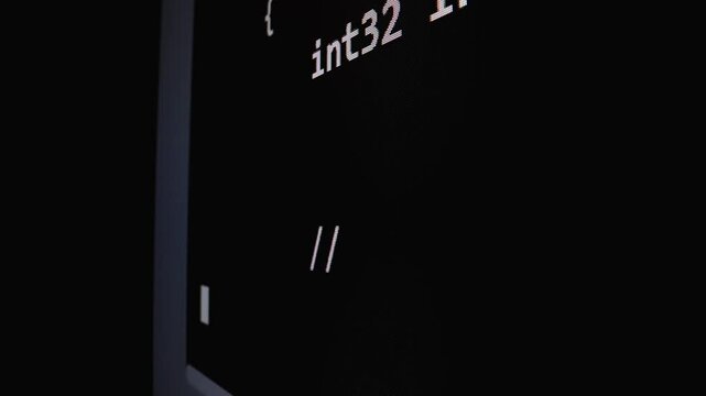 Closeup macro shot movement of coding script moving across LED screen with real-time AI-generated typing, showcasing advanced AI learning in optimization, debug and coding for software development.