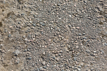 The texture of the asphalt surface, the background is gray asphalt. Rough stone surface of the road.