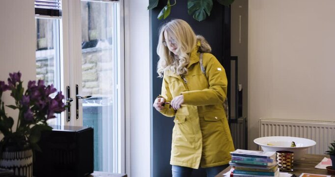 Woman, prepare and leave house with bag for shopping trip in the city. Mature woman getting ready and wearing winter coat for journey in cold town for consumer shop to buy or purchase items in home