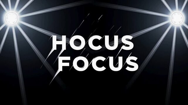 Hocus Focus spotlight text on black background with light beams