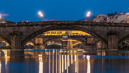 Naklejka premium Ponte Alla Carraia and Santa Trinita Holy Trinity Bridge day to night timelapse over River Arno in Florence