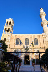 Fototapeta premium Orthodox church with a bell tower and a minaret in the town of Chania on the island of Crete