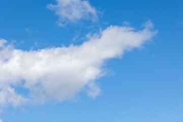 White clouds drifting across a vibrant blue sky
