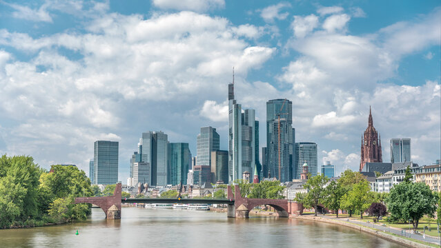 Hyperlapse of Frankfurt's skyscrapers skyline with the bell tower overlooking Alte Brucke. Frankfurt, Germany