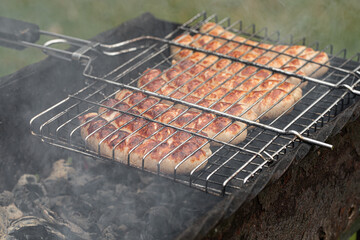 grilled sausages, cooking on the grill
